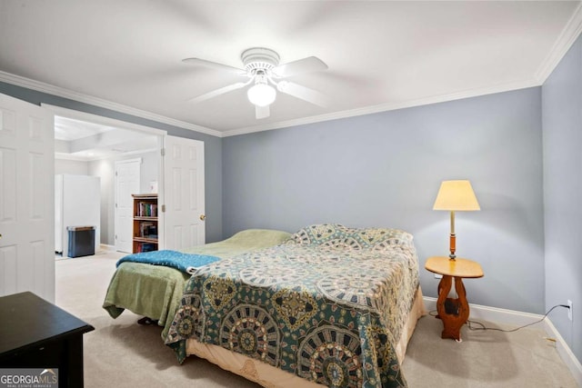 carpeted bedroom with ornamental molding, freestanding refrigerator, ceiling fan, and baseboards