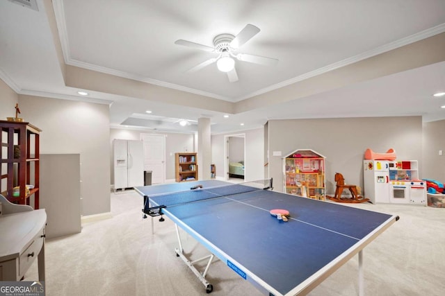 recreation room with a raised ceiling, ceiling fan, ornamental molding, carpet, and recessed lighting