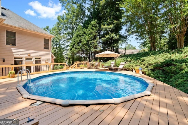 view of swimming pool featuring a wooden deck