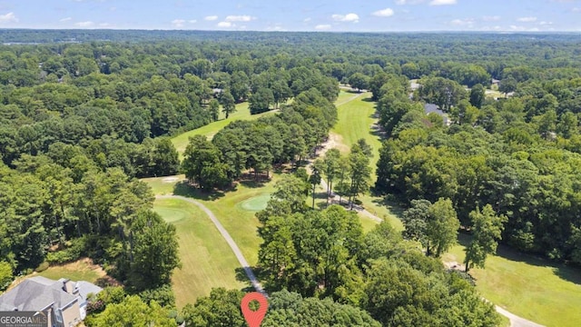 drone / aerial view featuring a forest view