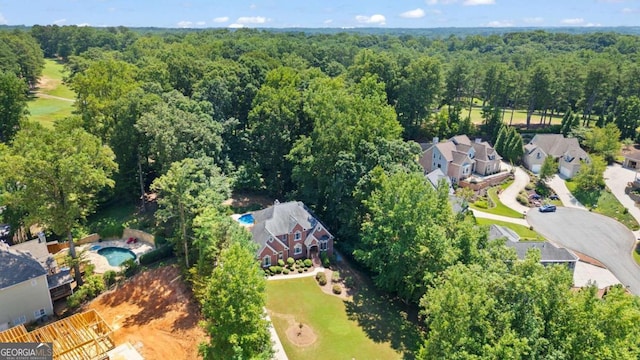 bird's eye view featuring a wooded view