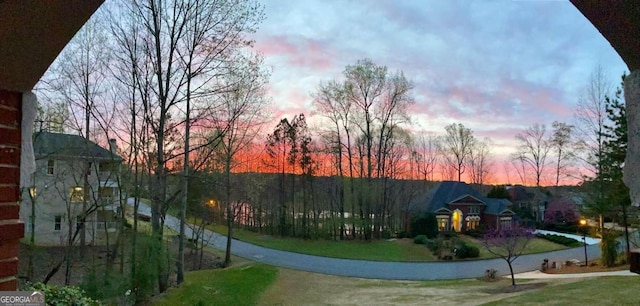 view of property's community featuring driveway and a yard