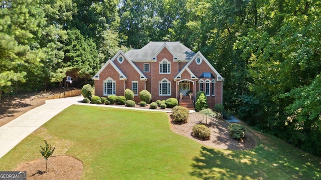 view of front of home with a front lawn and brick siding