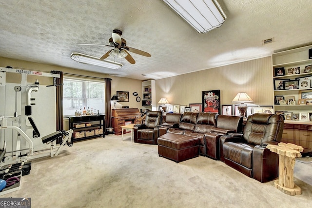 interior space featuring visible vents, ceiling fan, and a textured ceiling