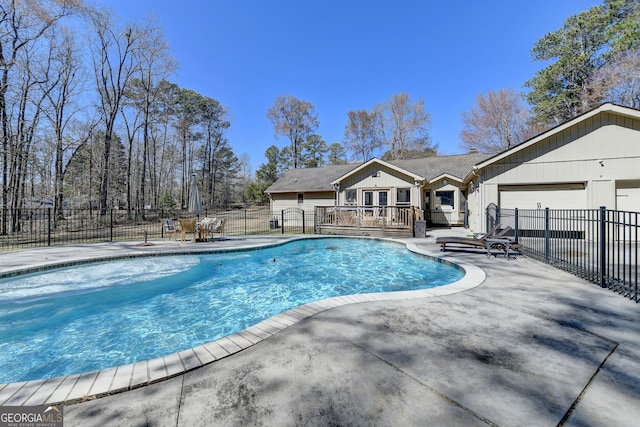 view of pool featuring a patio area, fence, a fenced in pool, and a wooden deck