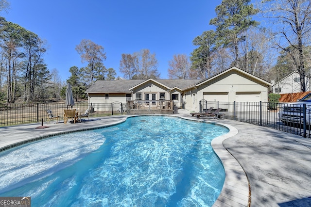 view of pool with fence, a deck, a fenced in pool, and a patio