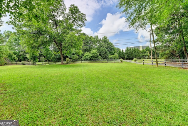 view of yard featuring a rural view and fence