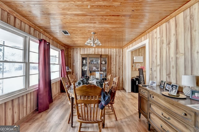 dining area featuring wooden ceiling, visible vents, light wood finished floors, and an inviting chandelier