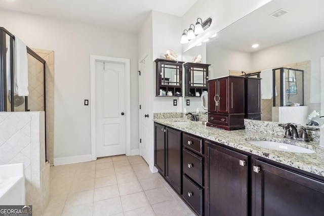 full bath with tile patterned flooring, a shower stall, visible vents, and a sink