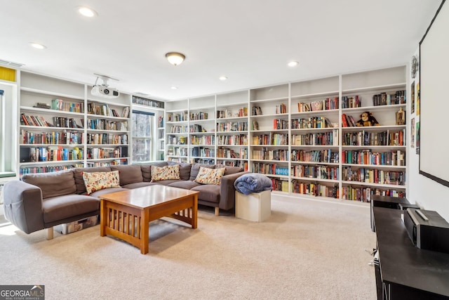 living area with bookshelves, carpet flooring, and recessed lighting