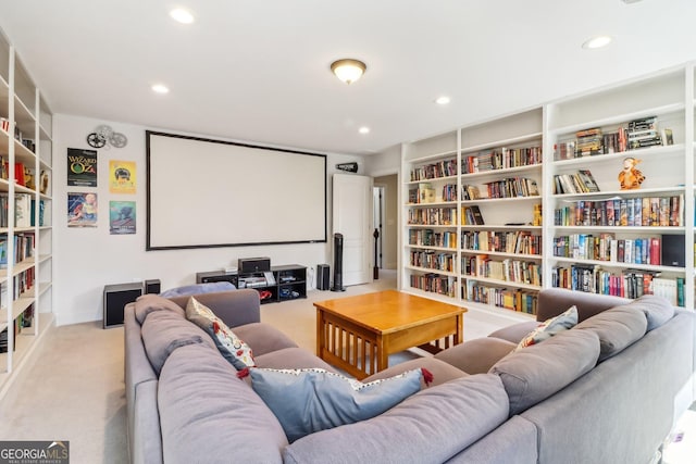 carpeted cinema room featuring built in shelves and recessed lighting