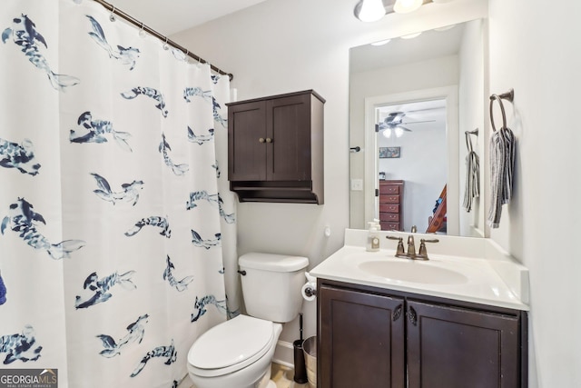 full bath featuring toilet, a shower with shower curtain, and vanity