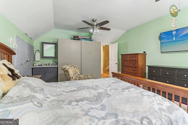 bedroom featuring lofted ceiling, ceiling fan, and connected bathroom