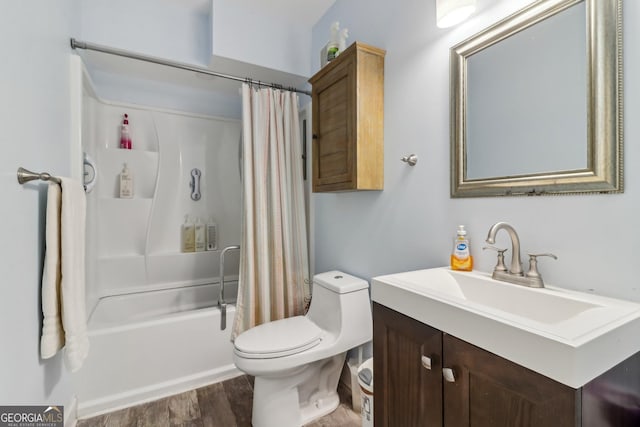 full bathroom with toilet, shower / bath combo with shower curtain, wood finished floors, and vanity