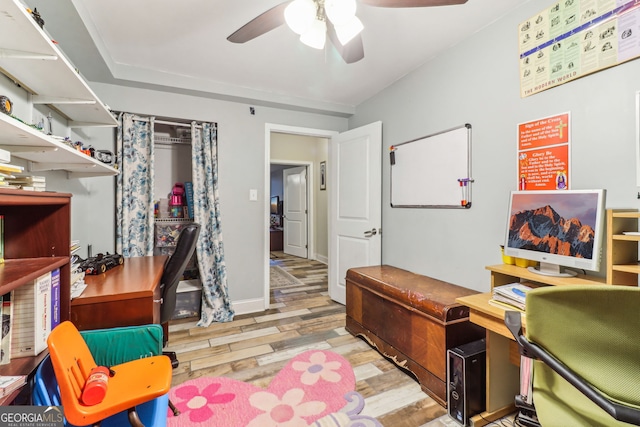 home office with baseboards, a ceiling fan, and wood finished floors