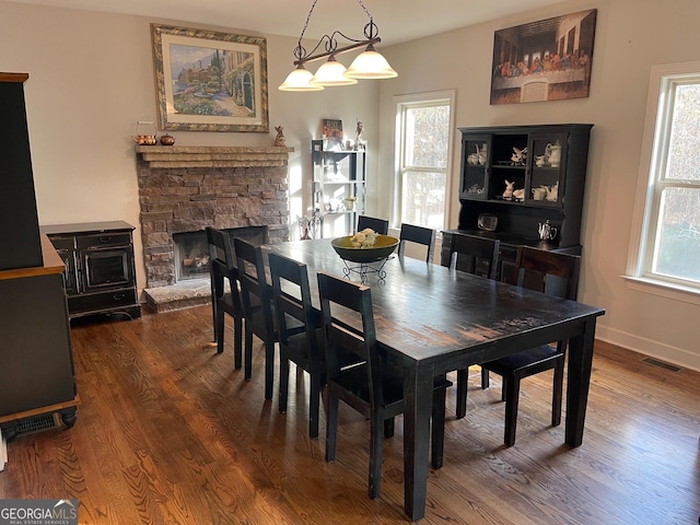 dining room with a healthy amount of sunlight, visible vents, and wood finished floors