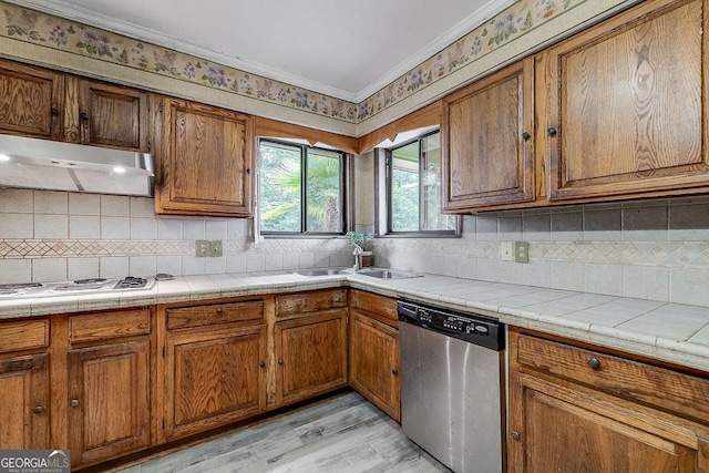 kitchen featuring white electric stovetop, brown cabinetry, dishwasher, under cabinet range hood, and a sink