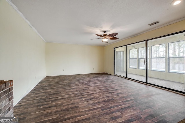 empty room featuring crown molding, visible vents, ceiling fan, and wood finished floors