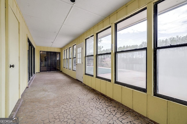 unfurnished sunroom featuring plenty of natural light