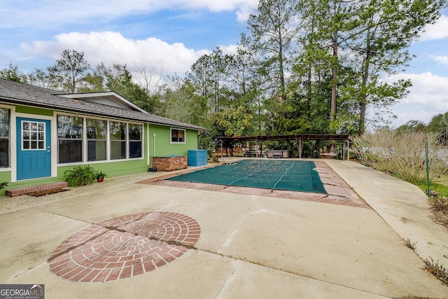 view of swimming pool with a covered pool and a patio