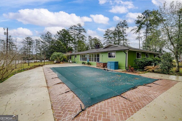 view of pool with a patio area and a covered pool