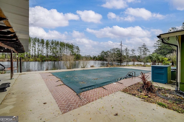 view of pool featuring a water view, a fenced in pool, and a patio