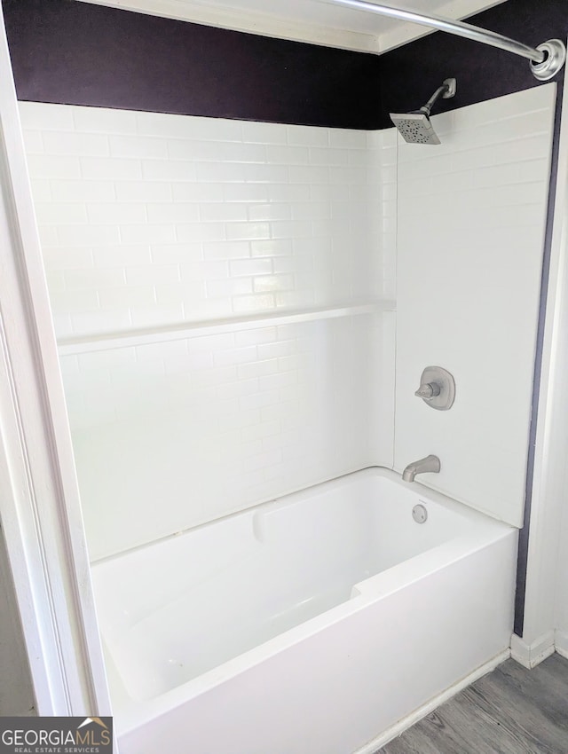 full bath with shower / bath combination and wood finished floors