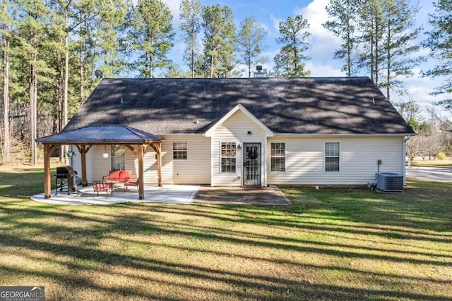back of property featuring a gazebo, a patio, cooling unit, and a lawn