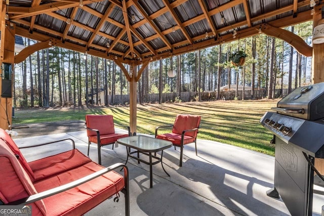 view of patio featuring grilling area and fence