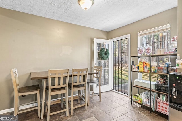 dining area featuring a textured ceiling