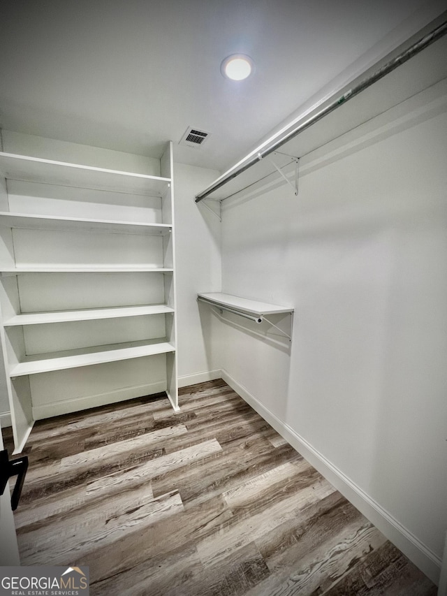 spacious closet with wood finished floors and visible vents