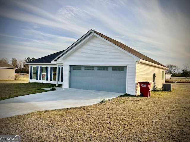 view of front facade with driveway, a shingled roof, central AC unit, an attached garage, and a front lawn