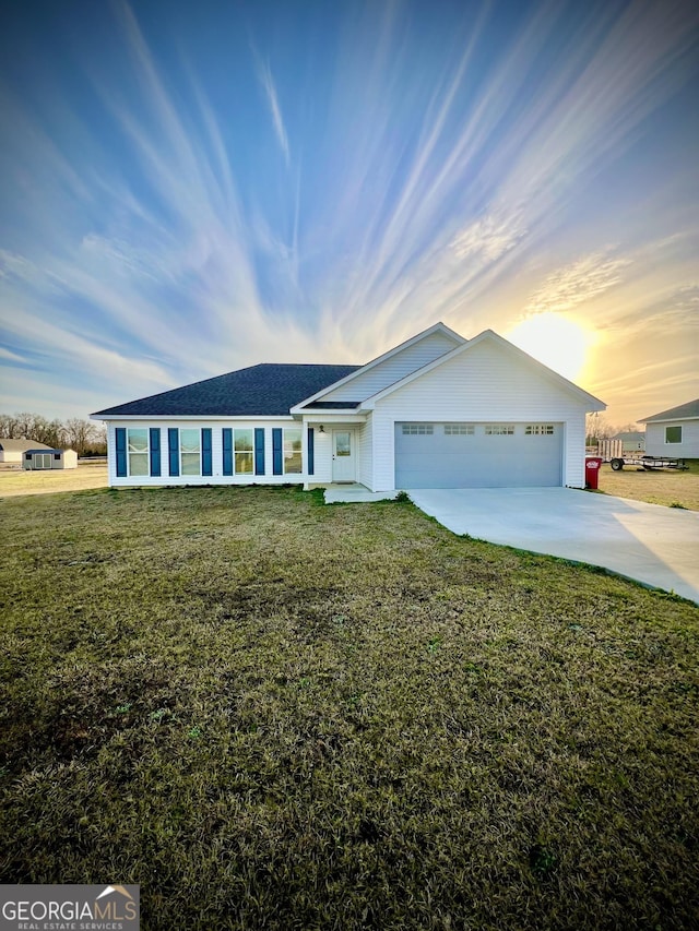 single story home with a garage, driveway, and a front yard