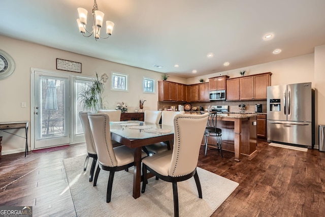 dining room featuring recessed lighting, dark wood-style flooring, baseboards, and an inviting chandelier