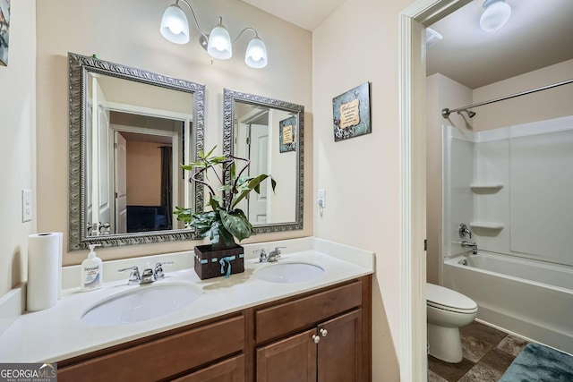 bathroom featuring double vanity, bathtub / shower combination, a sink, and toilet