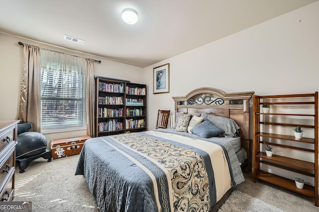 carpeted bedroom featuring visible vents