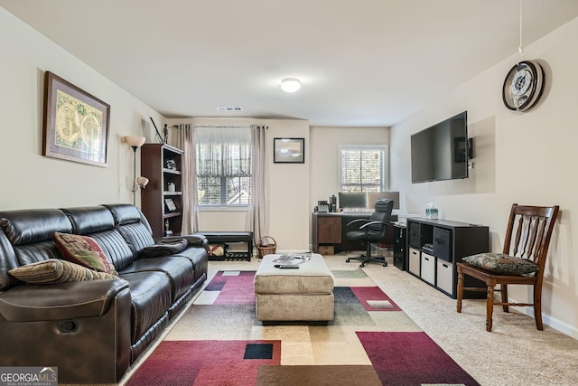 living room with visible vents and baseboards