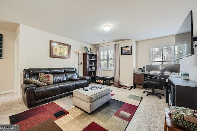 living room with light colored carpet, visible vents, and baseboards