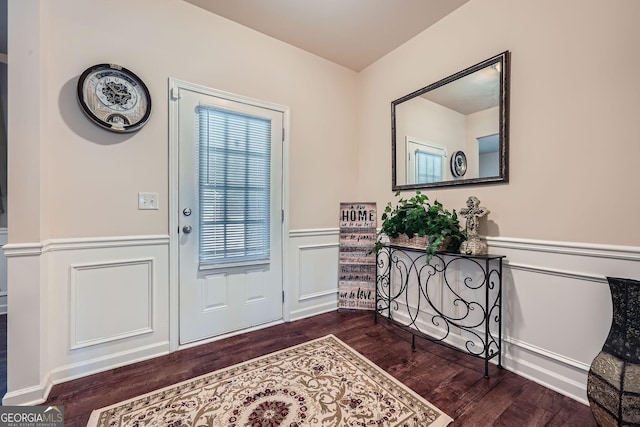 entrance foyer with dark wood-type flooring and wainscoting