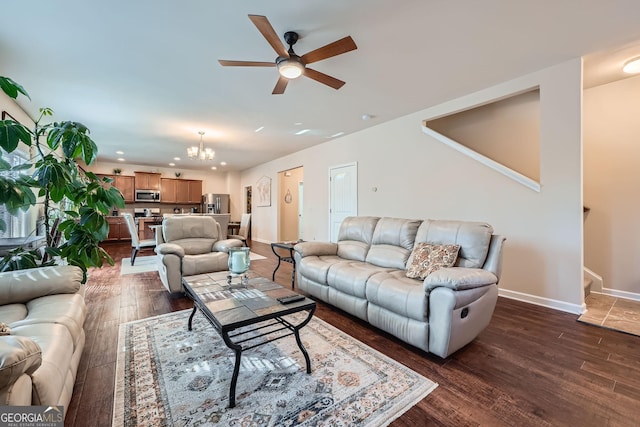 living area featuring dark wood-style flooring, recessed lighting, ceiling fan with notable chandelier, baseboards, and stairs