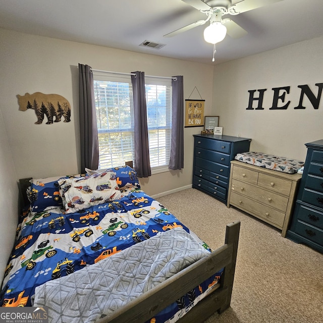 bedroom featuring baseboards, carpet flooring, visible vents, and a ceiling fan