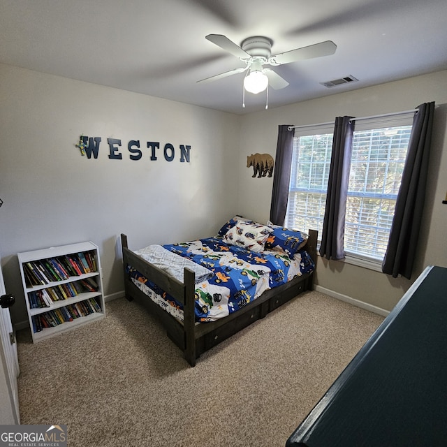 carpeted bedroom with baseboards, visible vents, and ceiling fan