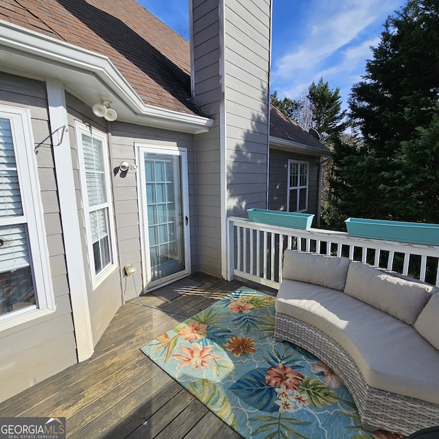 wooden terrace featuring an outdoor living space