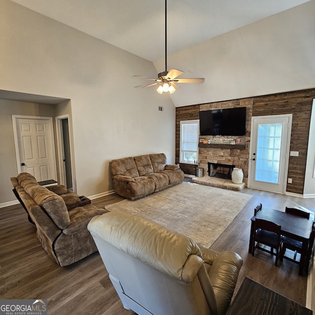 living room featuring ceiling fan, a fireplace, high vaulted ceiling, and wood finished floors