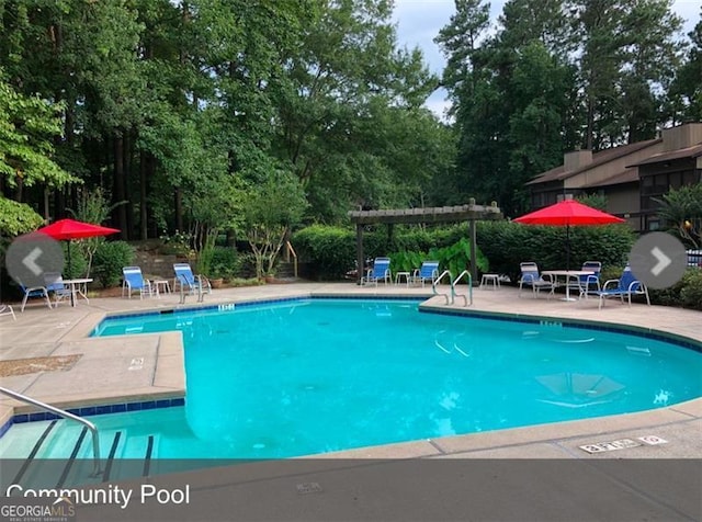 community pool featuring a patio area and a pergola