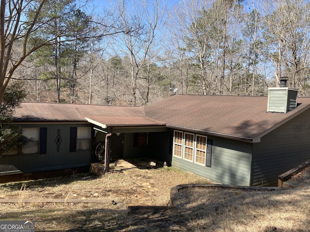 view of front of home featuring a chimney