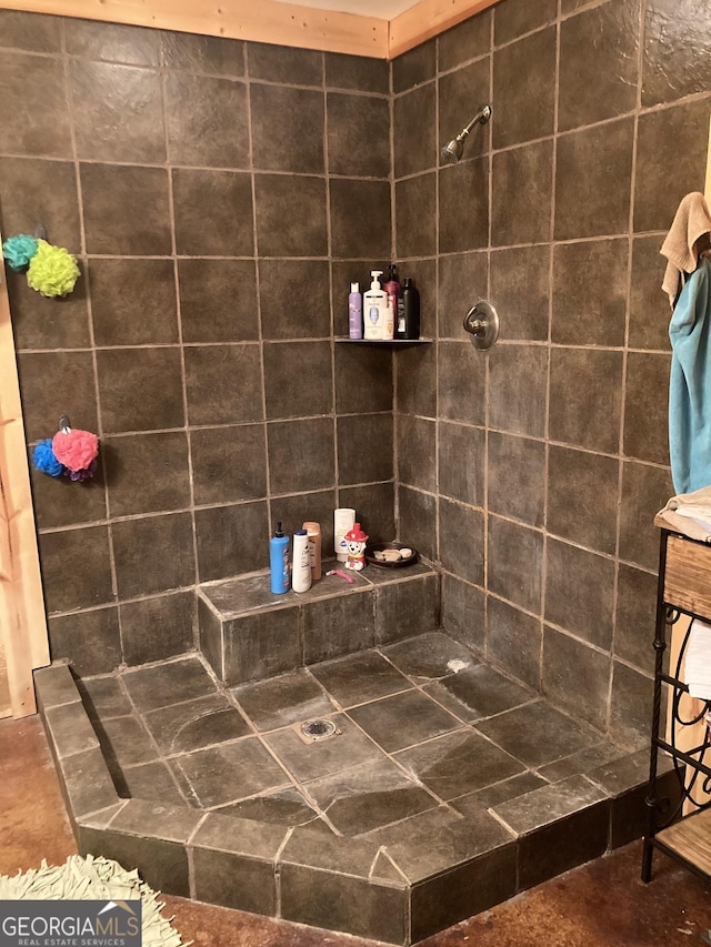 bathroom with a tile shower