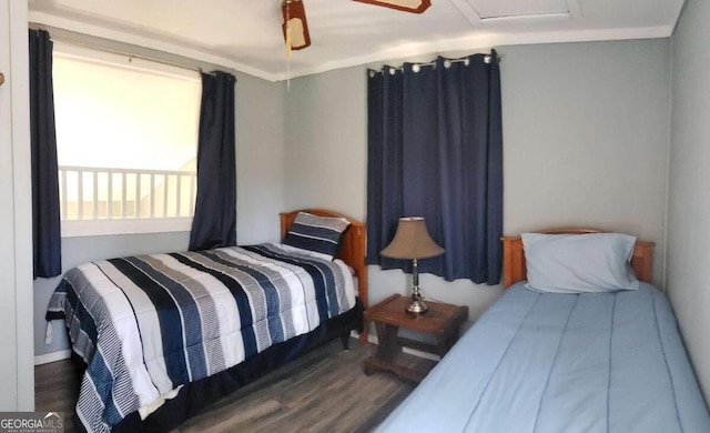 bedroom with attic access and wood finished floors