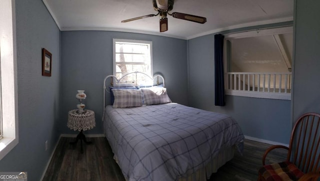 bedroom with ceiling fan, baseboards, wood finished floors, and crown molding