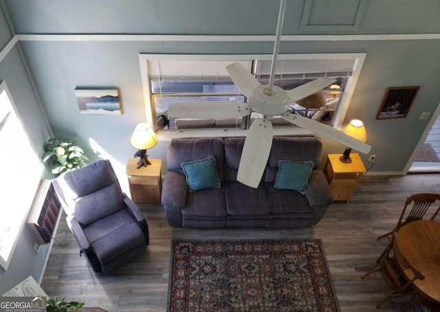 living area featuring baseboards and wood finished floors